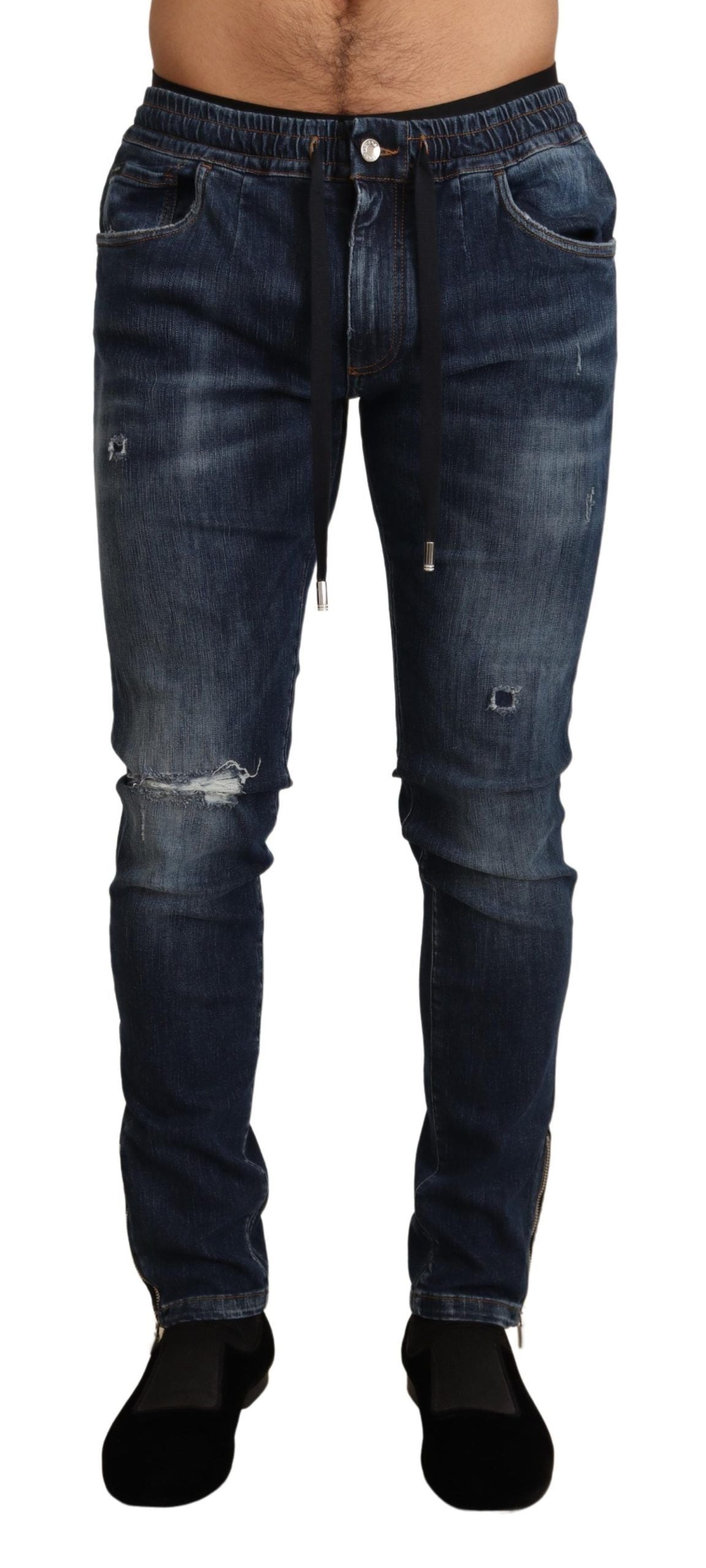 Jeans en denim tattered bleu en coton extensible de Dolce & Gabbana, coupe décontractée et détails usés visibles.