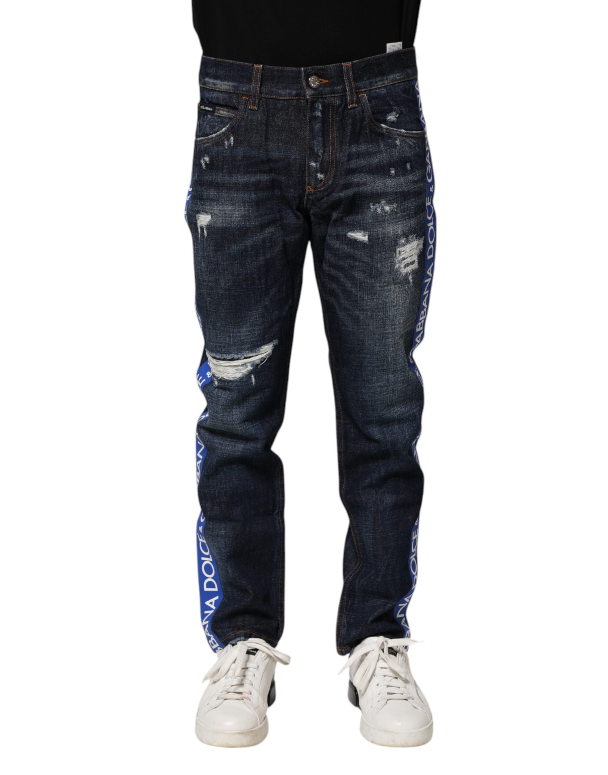 Jeans skinny en denim bleu foncé déchiré de Dolce & Gabbana, style tattered, ajustés, avec détails usés et déchirés visibles.