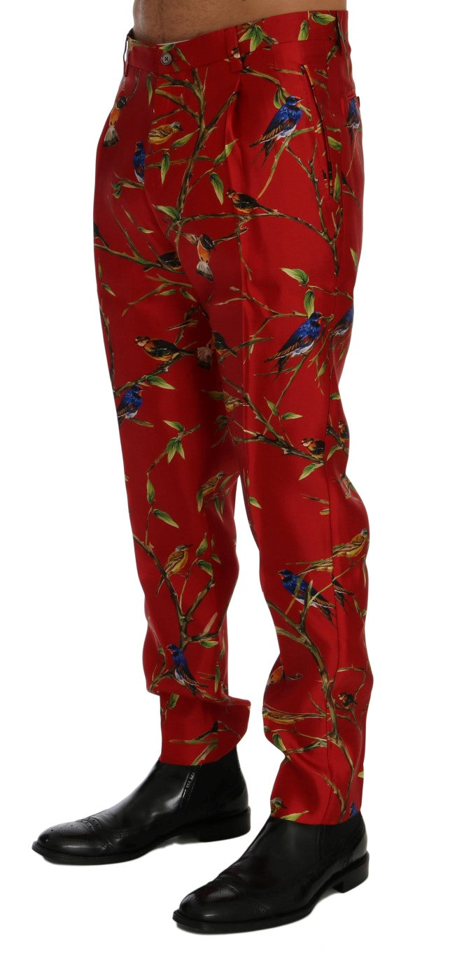Pantalon Dolce & Gabbana en soie rouge avec imprimé d'oiseaux, élégant et fluide, pour un style sophistiqué.
