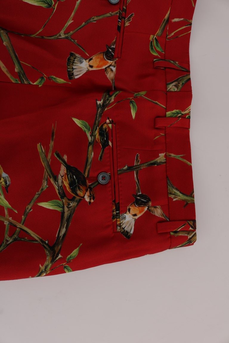 Pantalon Dolce & Gabbana en soie rouge avec motif oiseau, pantalon élégant en tissu fluide et coloré.