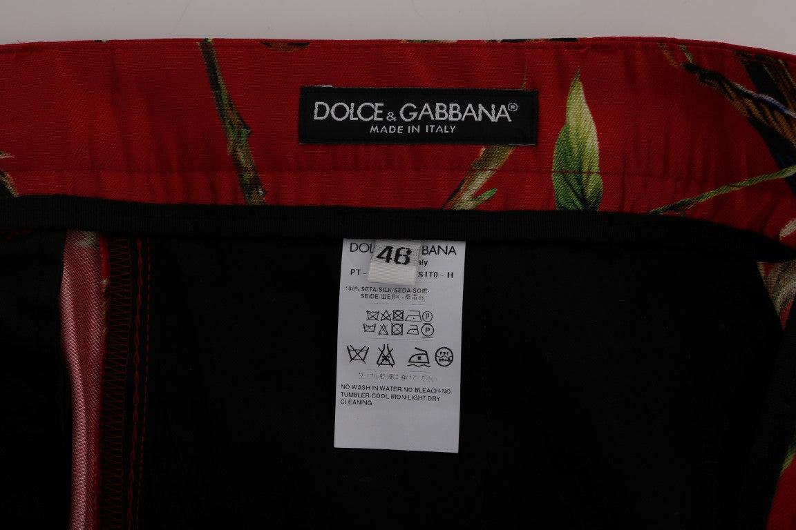 Pantalons de soie rouge Dolce & Gabbana avec imprimé d'oiseaux élégants, style chic et sophistiqué pour femmes.