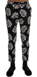 Pantalon slim en coton stretch blanc et noir avec motif feuilles de Dolce & Gabbana, style élégant et moderne.