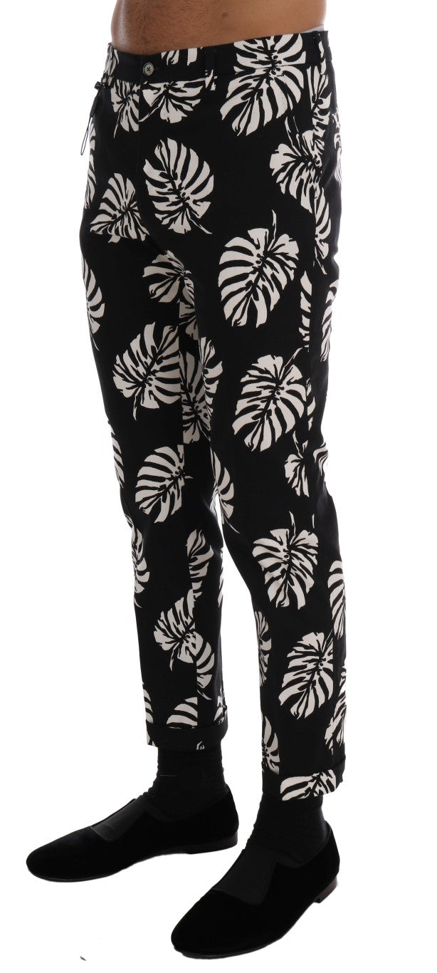 Pantalons slim en coton stretch blanc et noir avec motif de feuilles de Dolce & Gabbana, style élégant et moderne.