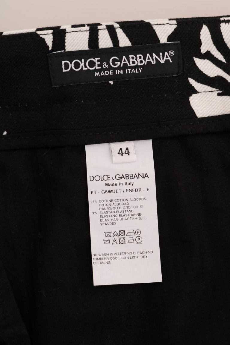 Pantalon slim en coton stretch blanc et noir à motif feuilles de Dolce & Gabbana, coupe élégante et moderne.