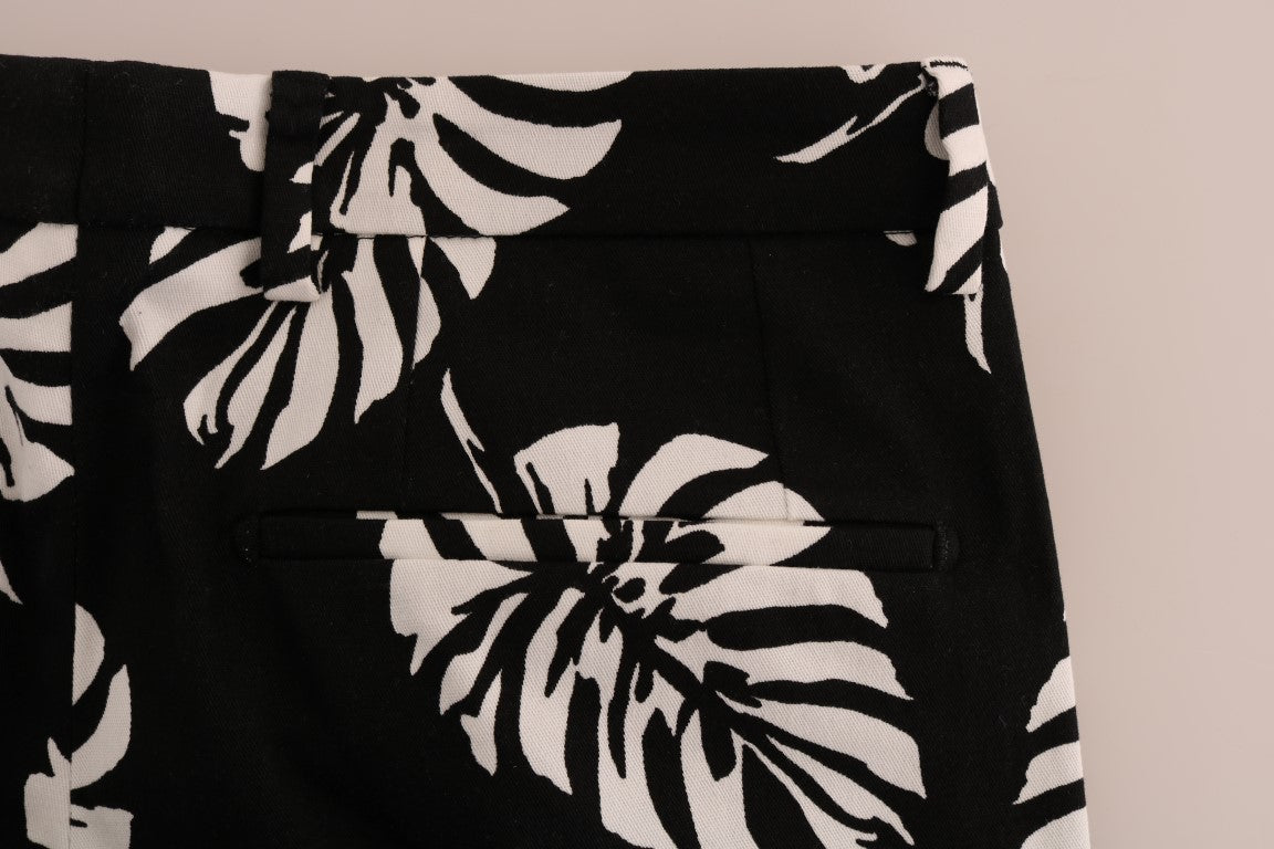 Pantalons slim en coton stretch blanc et noir avec motif de feuilles de Dolce & Gabbana, style élégant et moderne.