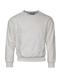 Pull Dolce & Gabbana en coton blanc à col rond, doux et confortable, visible avec le logo discret sur la poitrine.