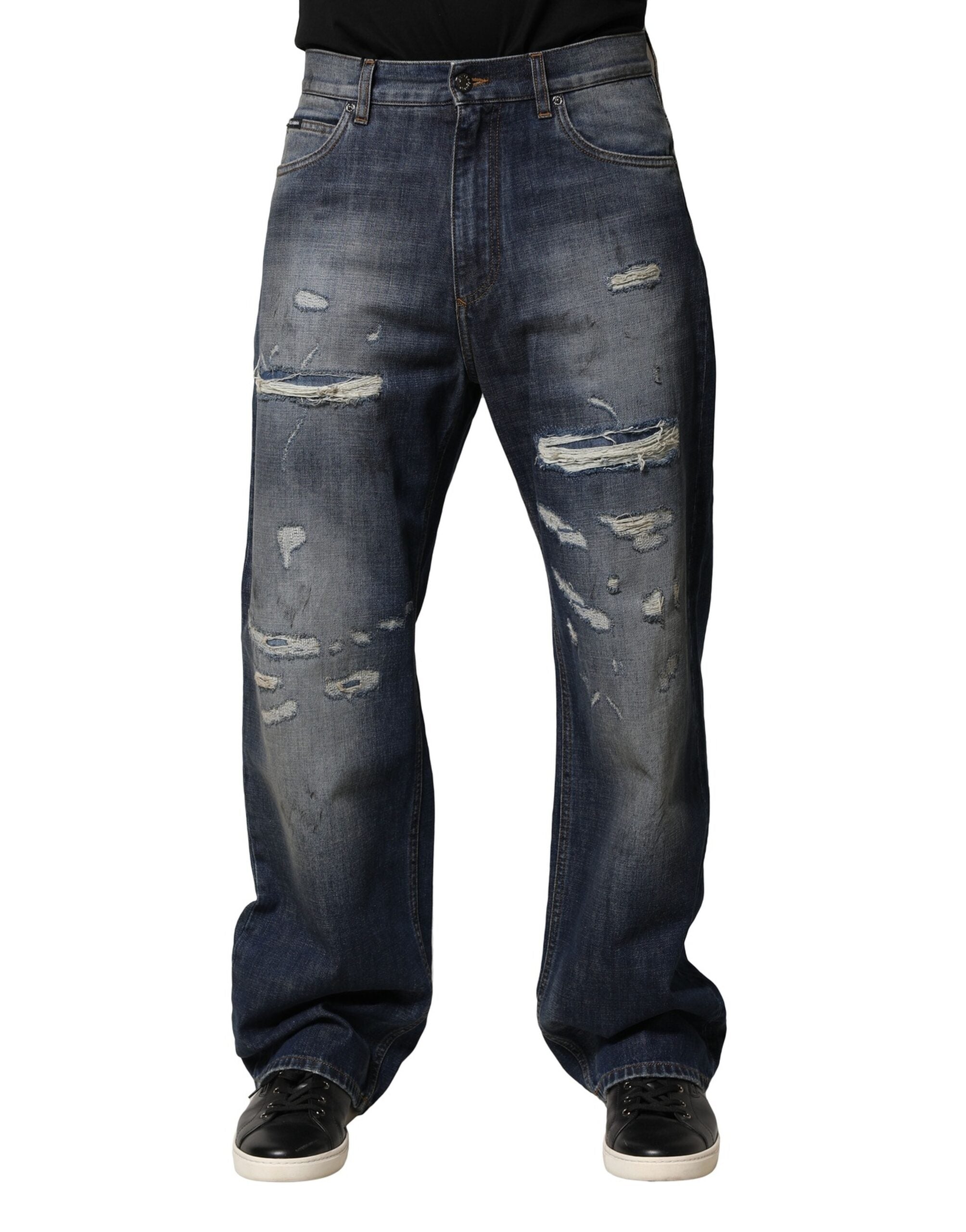 Jeans hommes en coton délavé et usé de Dolce & Gabbana, style tattered, bleu, avec détails déchirés.