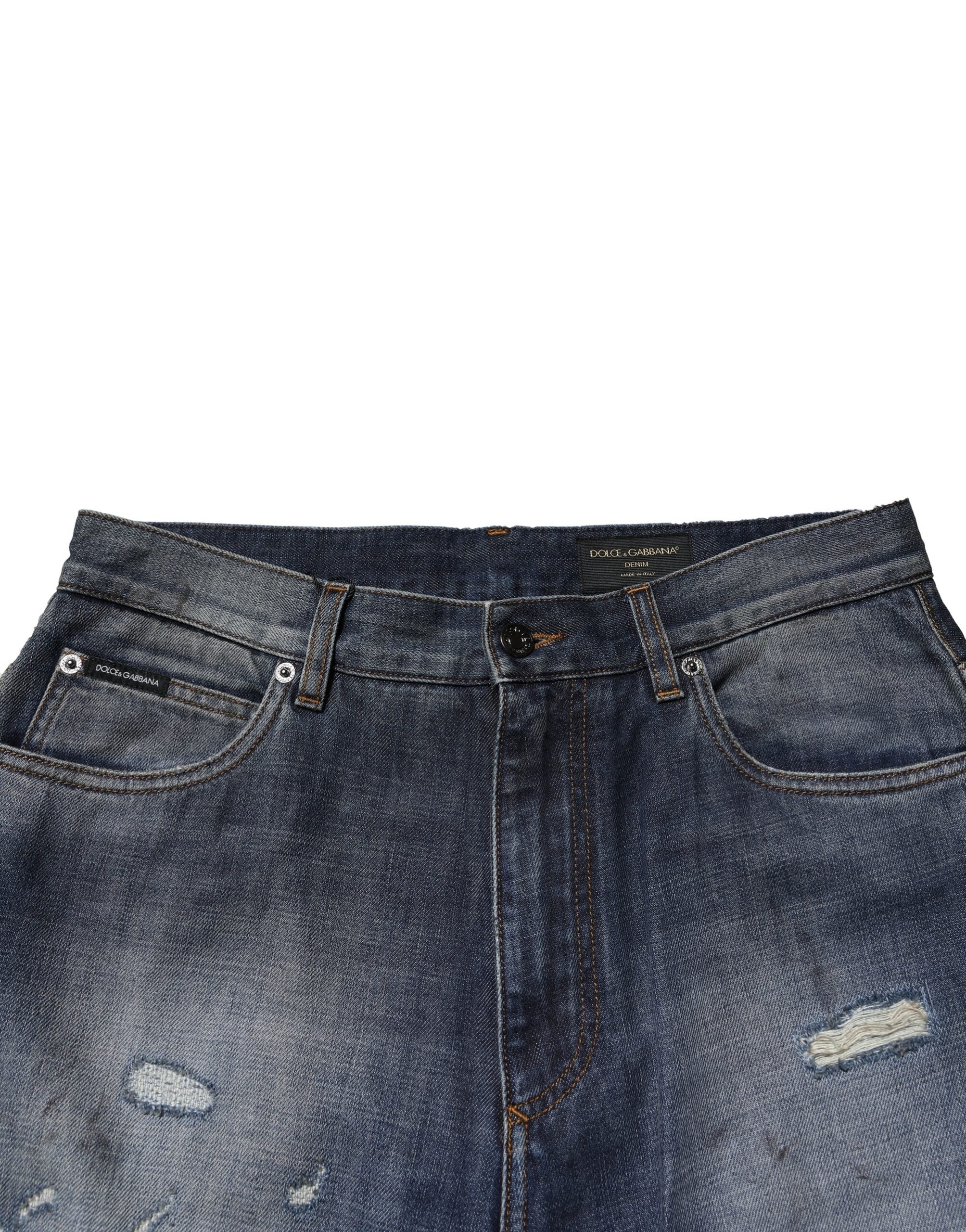 Jeans homme en coton délavé et déchiré Dolce & Gabbana, style usé et tendance, avec détails tachetés.