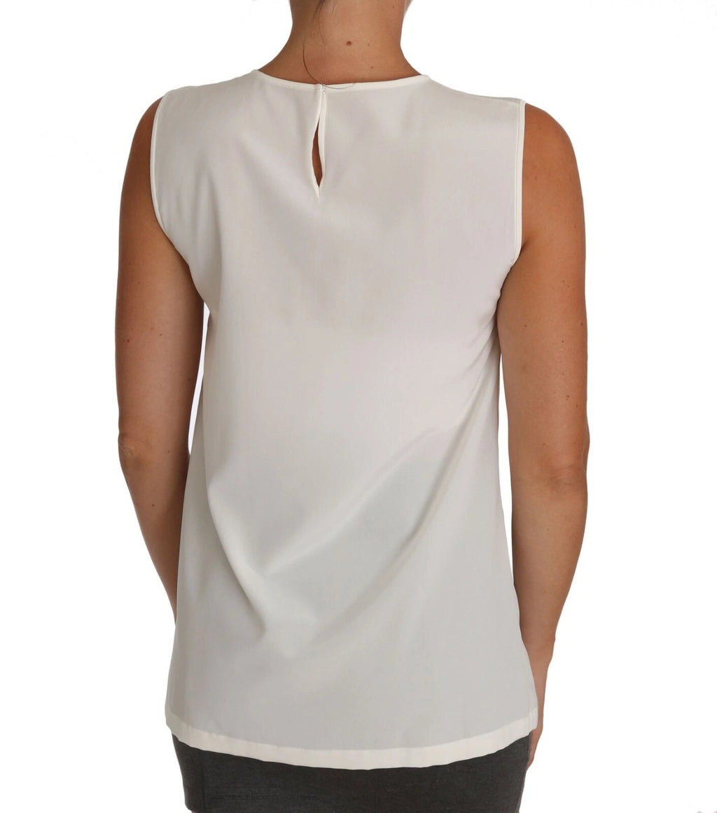 Top blanc Dolce & Gabbana avec embellissements de cristaux et sequins, style féerique et élégant.