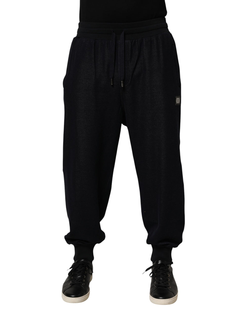 Pantalon jogger Dolce & Gabbana en coton mélangé noir avec cordons de serrage et poches latérales, vue de face.