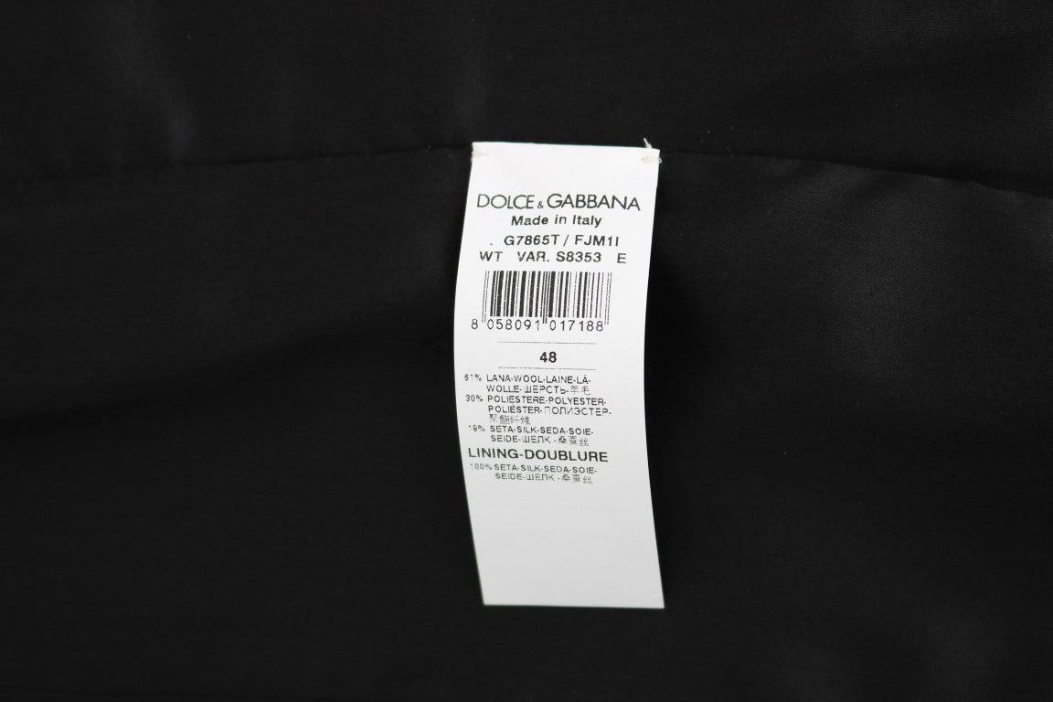 Gilet à pois noir de Dolce & Gabbana avec motif à pois, porté, en tissu élégant, détail de mode sophistiqué.