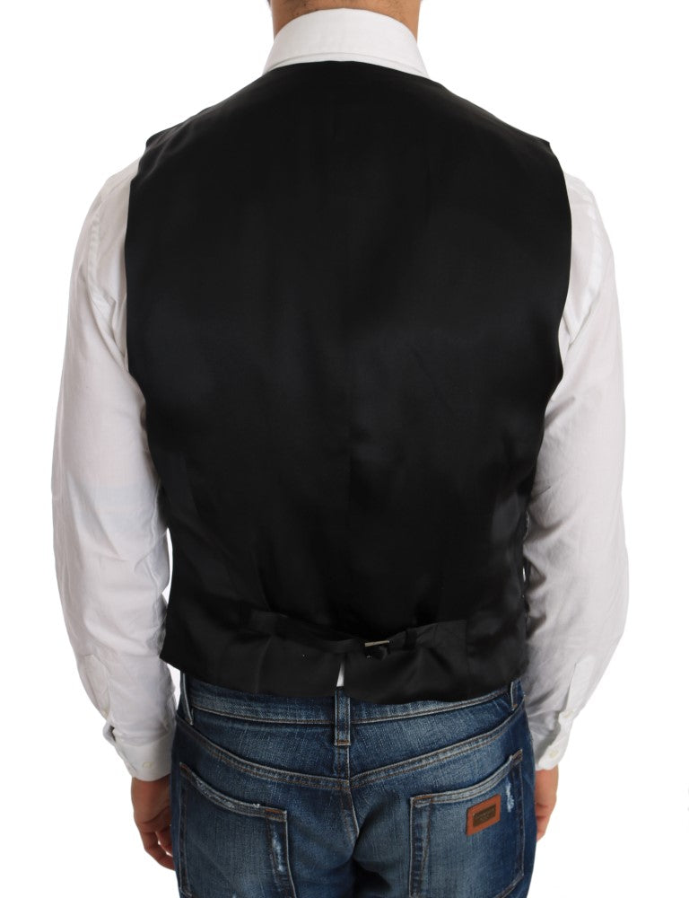 Gilet en laine et soie noir de Dolce & Gabbana, finition élégante, porté sur un fond neutre, vue de face.