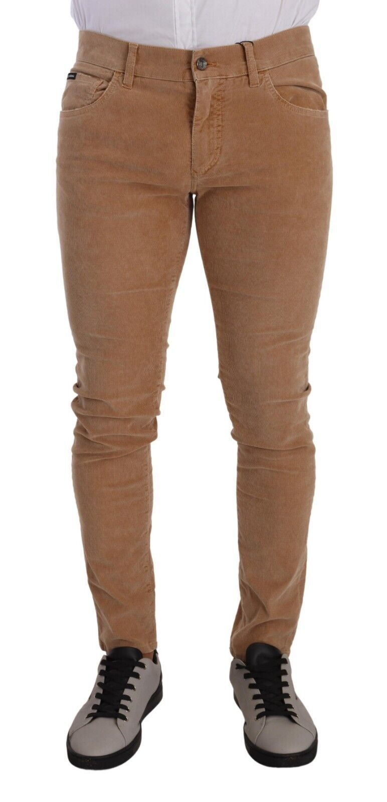 Jeans slim en coton corduroy marron de Dolce & Gabbana, coupe skinny et ajustée, visibles avec détails de couture et fermeture éclair.