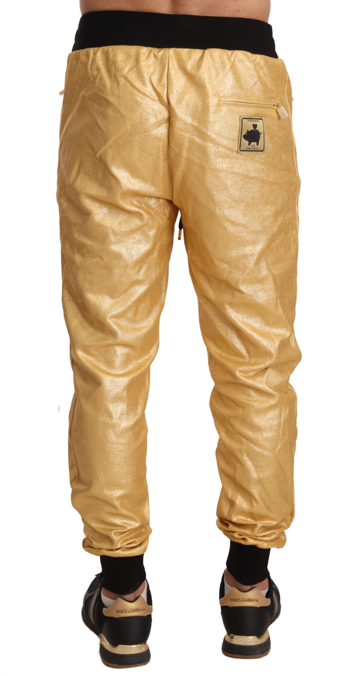 Pantalon en coton doré Dolce & Gabbana Pig Of The Year, pantalon élégant avec motif de cochon doré, style luxueux.