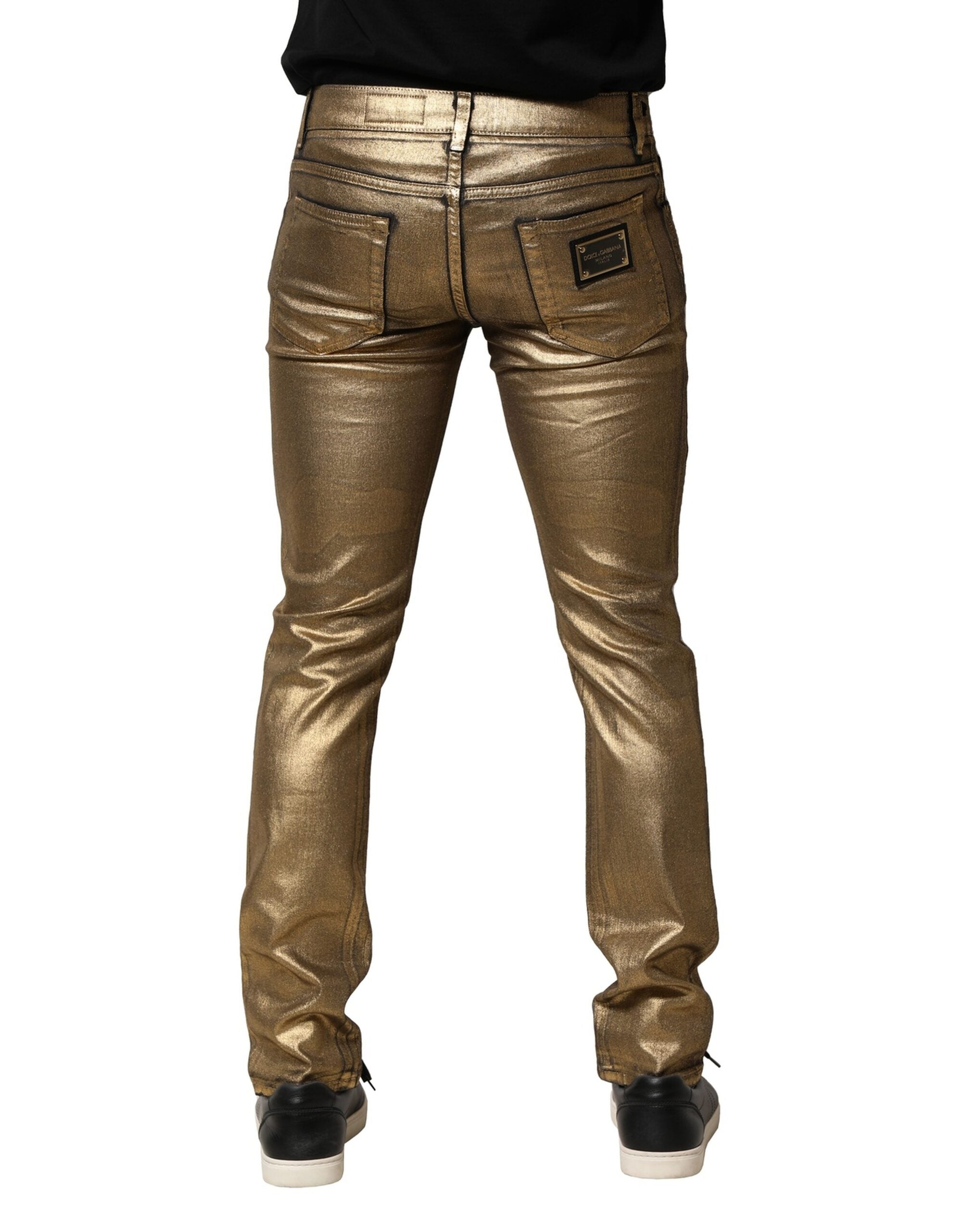 Jeans slim en denim doré tacheté en coton stretch de Dolce & Gabbana, avec finition déchirée et détails mode.