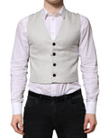 Gilet en laine gris Dolce & Gabbana pour homme, costume formel, détail élégant, porté sur une chemise blanche.