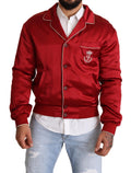 Veste bomber en soie rouge Dolce & Gabbana avec boutons et logo DG visible sur l'avant.