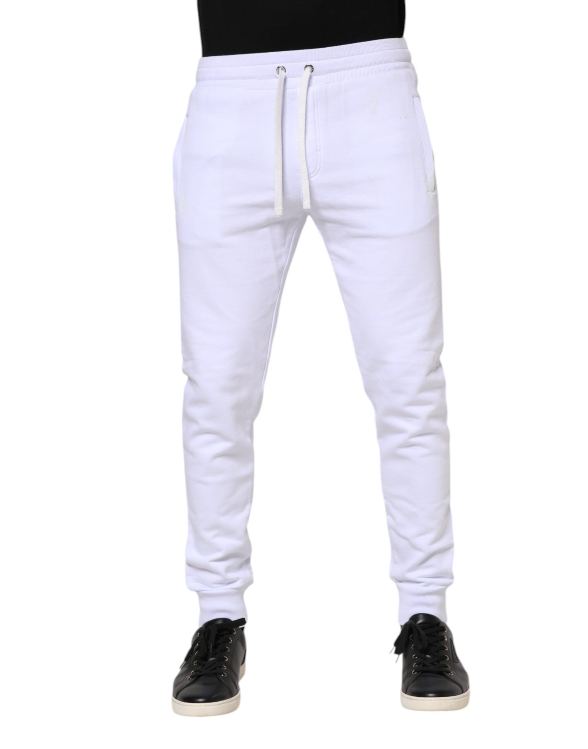 Pantalons joggers en coton blanc avec cordon de serrage de la marque Dolce & Gabbana, vue de face sur fond neutre.