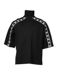 T-shirt à col roulé en coton noir Dolce & Gabbana avec motif DG, vue de face sur fond neutre.