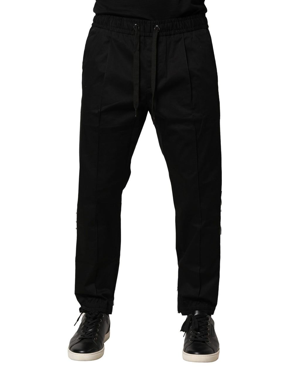 Pantalons jogger noirs en coton Dolce & Gabbana, taille mi-haute, avec détails de couture visibles sur le tissu.