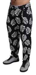 Pantalon noir Dolce & Gabbana en coton stretch avec motif de feuilles, coupe élégante et moderne.