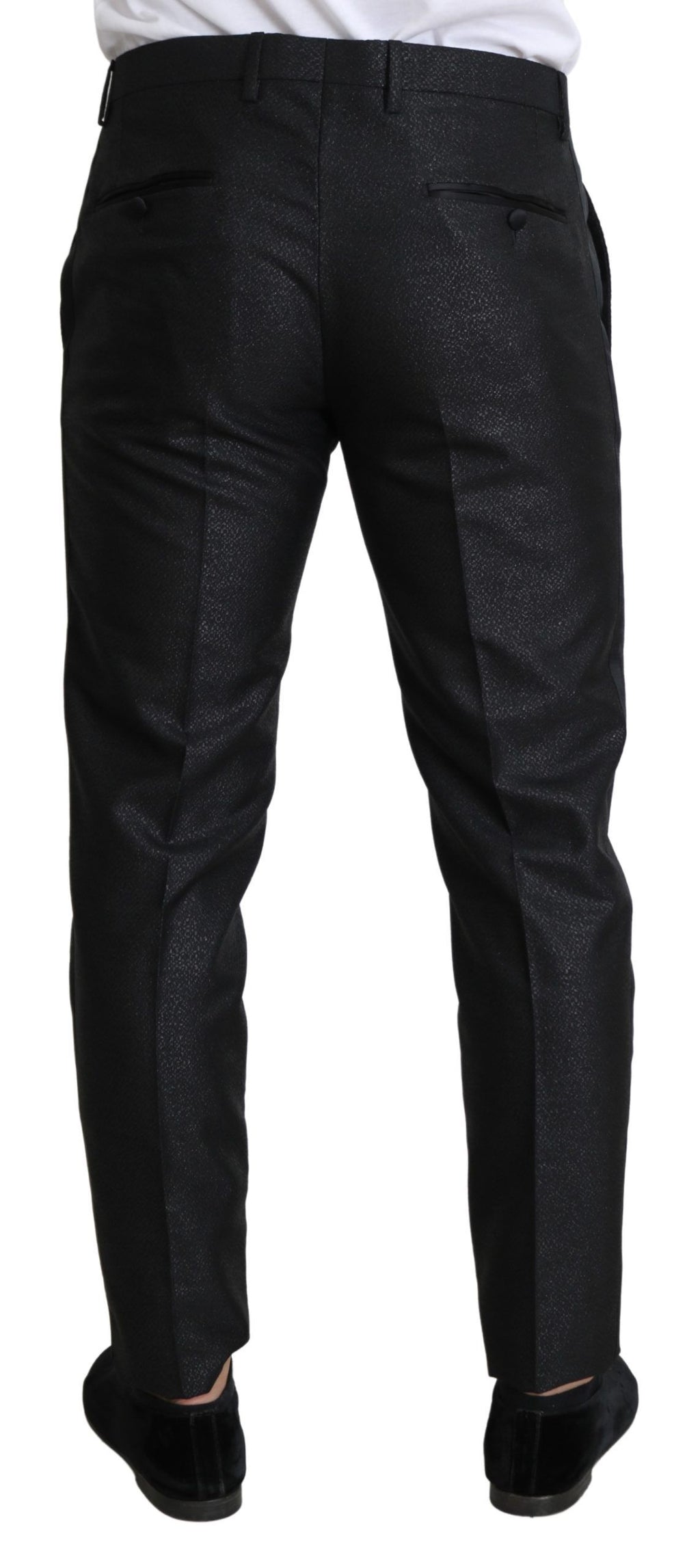 Robe pantalon skinny noire en métal doré de Dolce & Gabbana, tissu brillant et ajusté, élégante tenue de soirée.