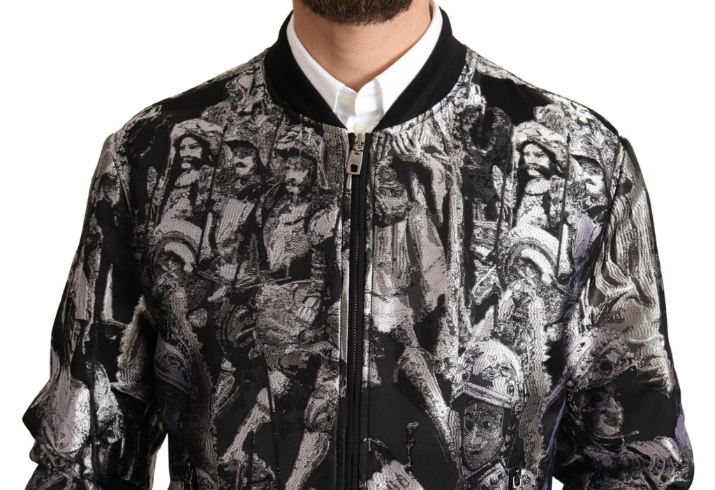 Veste bomber Dolce & Gabbana noire et argent avec motif Puppi, design élégant et moderne, en tissu brillant et finition soignée.