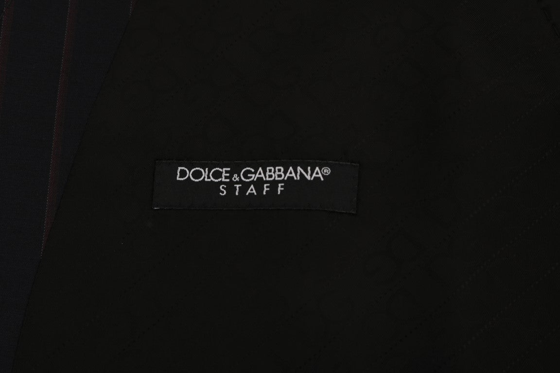 Gilet en laine extensible bleu Dolce & Gabbana, coupe ajustée, détail élégant, porté sur un fond neutre.