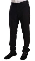 Pantalon de smoking en laine noire Dolce & Gabbana, pantalon formel élégant pour homme, détail visible de la couture et de la coupe.