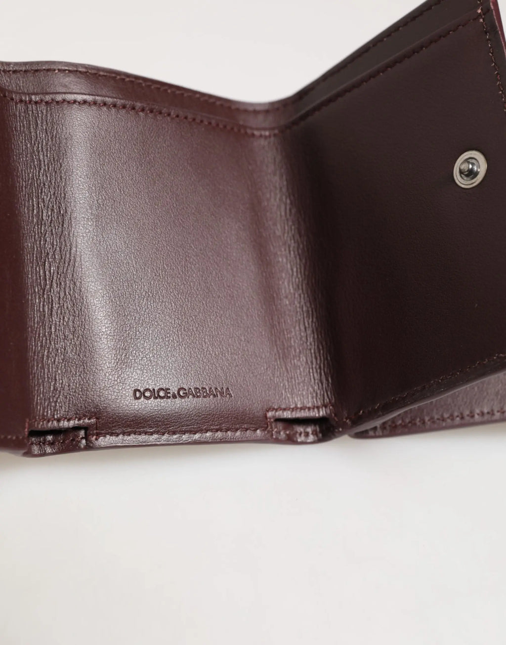 Portefeuille homme dolce gabbana en cuir marron foncé avec logo embossé texture subtile et couture précise