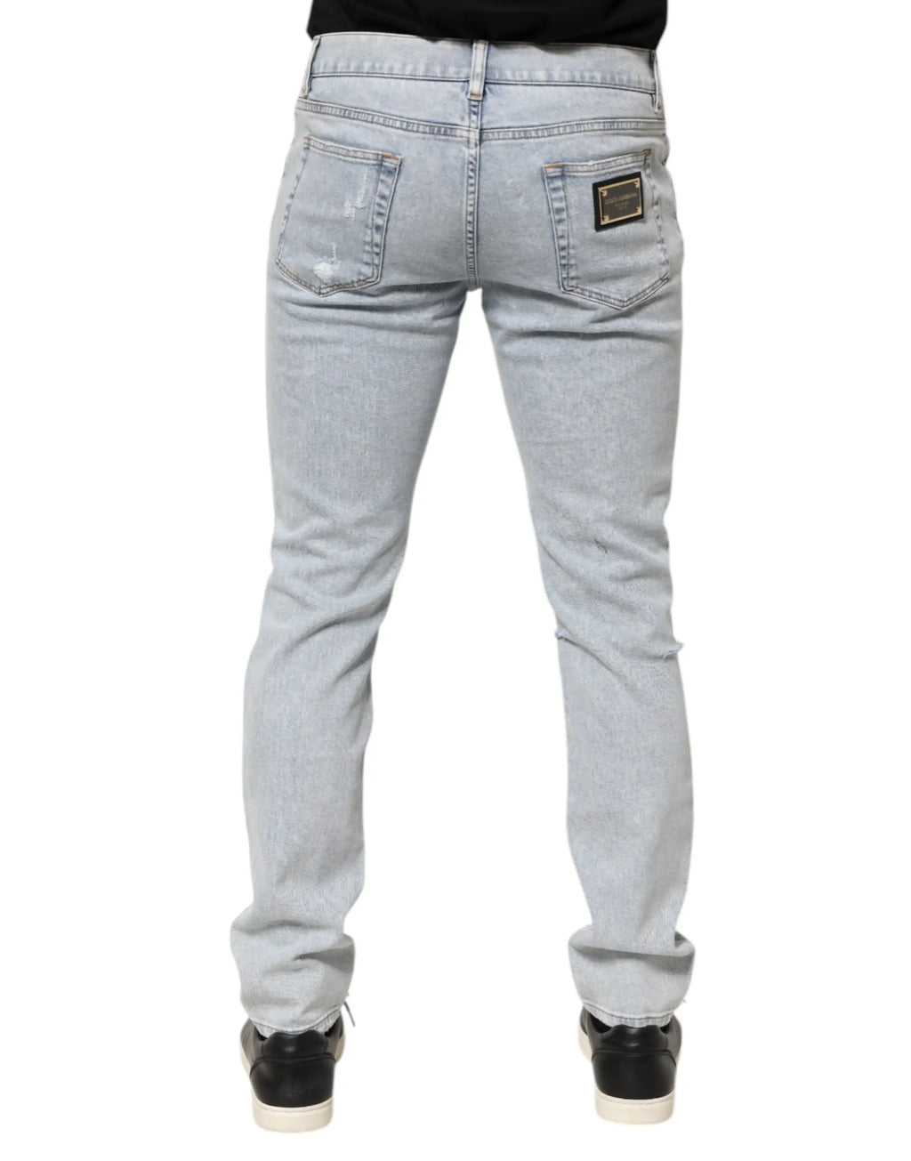Jeans slim fit en denim bleu clair délavé avec déchirures subtiles et patch Dolce & Gabbana au dos à droite