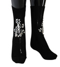 Chaussettes en maille noire Dolce & Gabbana avec motifs floraux et cristaux transparents, élégantes et sophistiquées.