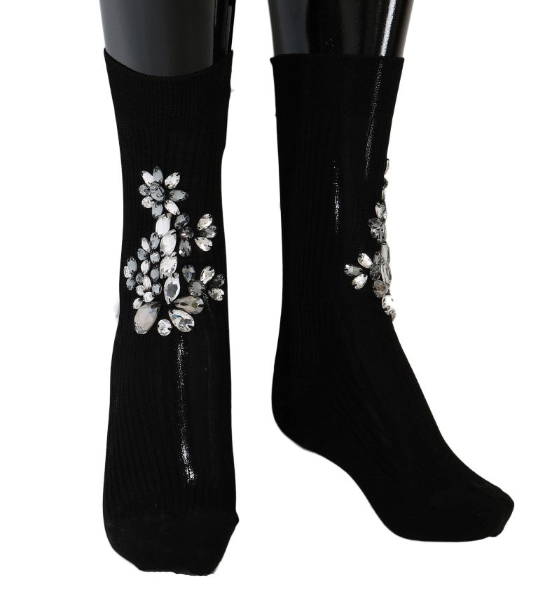 Chaussettes en maille noire Dolce & Gabbana avec motifs floraux et cristaux transparents, élégantes et sophistiquées.