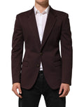 Un blazer sur mesure dolce & gabbana en coton bordeaux foncé avec fermeture à deux boutons et revers crantés classique