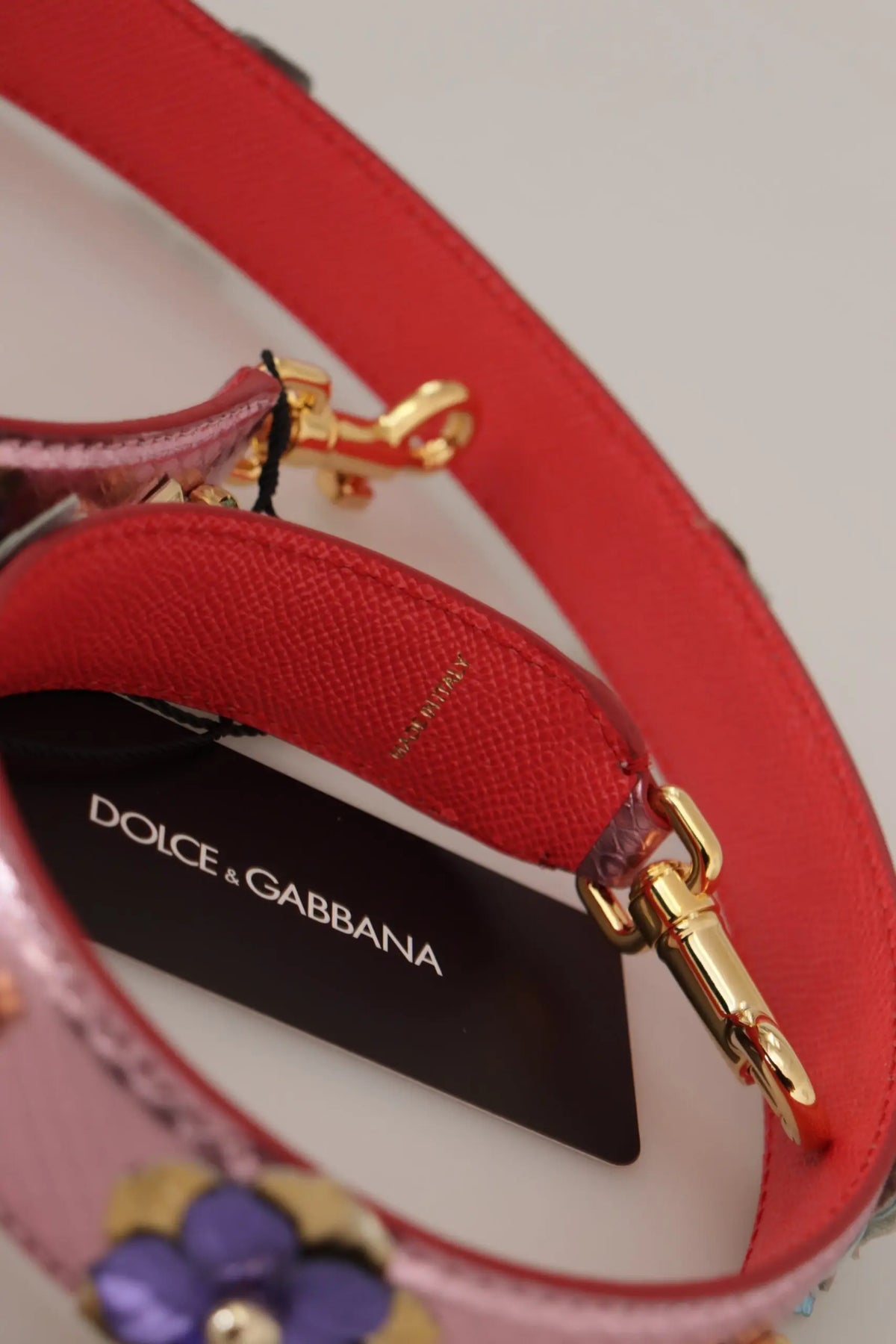 Red leather shoulder strap with gold-tone hardware floral embellishments and dolce gabbana brand tag