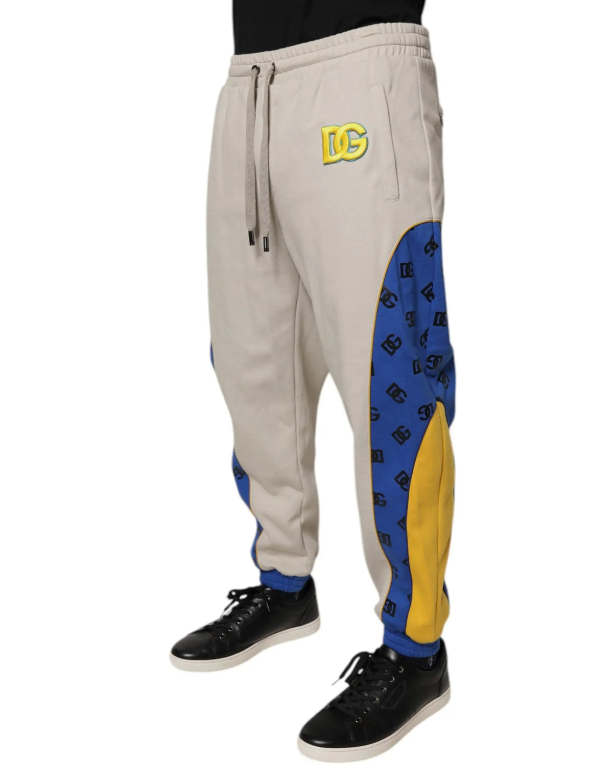 Joggers dolce gabbana multicolore en coton beige et bleu avec panneaux jaunes et motif logo répétitif sur le côté