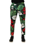 Dolce & Gabbana pantalon homme en coton à imprimé floral multicolore avec fleurs rouges, lys blancs, et feuilles monstera vertes