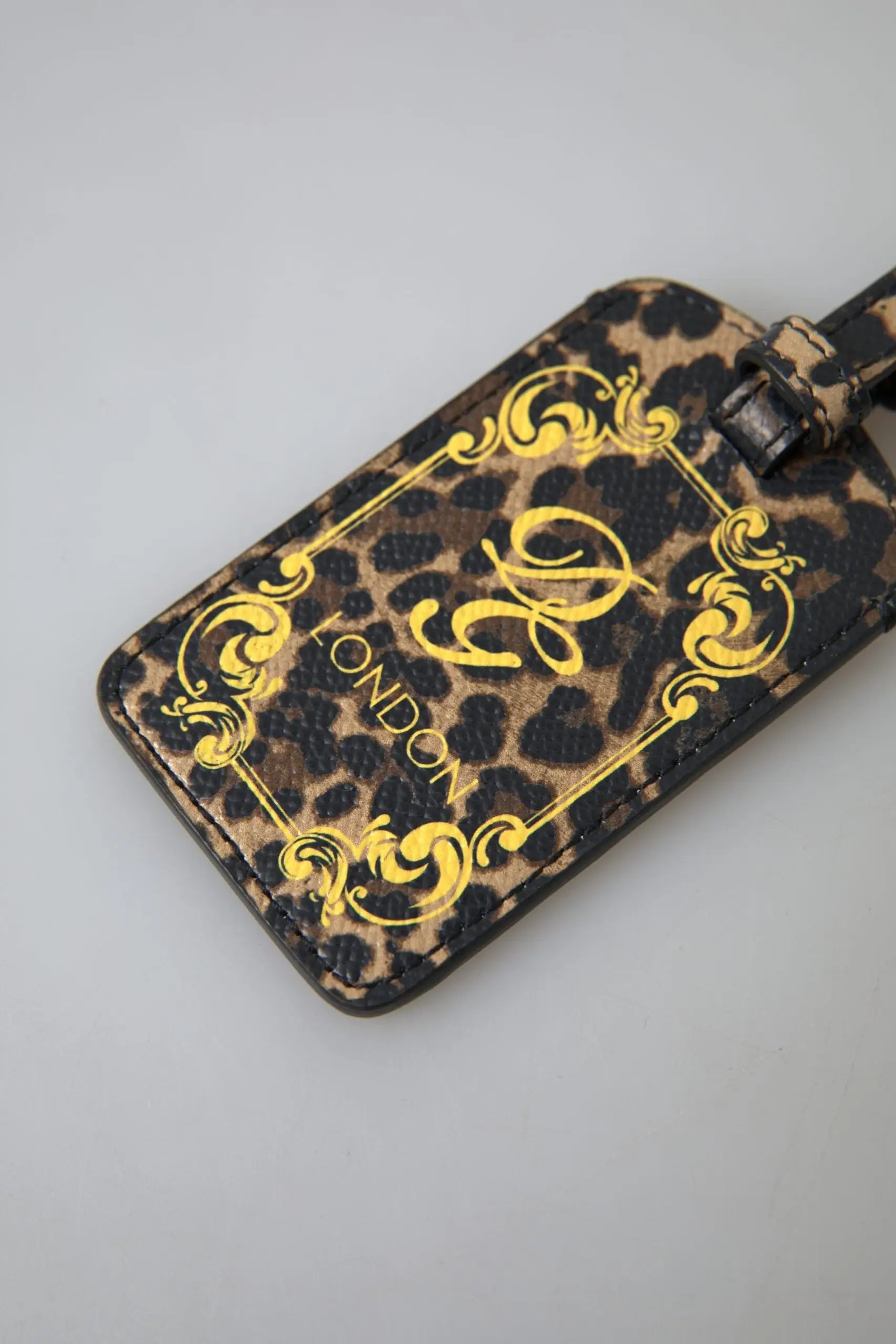 Étiquette à bagage en cuir dauphine leopard multicolore dolce & gabbana avec détails dorés et texte london embossé