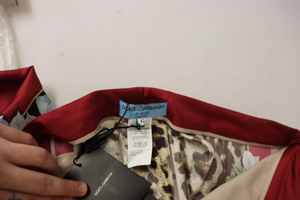 Red satin waistband with leopard print interior and dolce & gabbana tag on multicolor leopard flora printed mid waist trousers