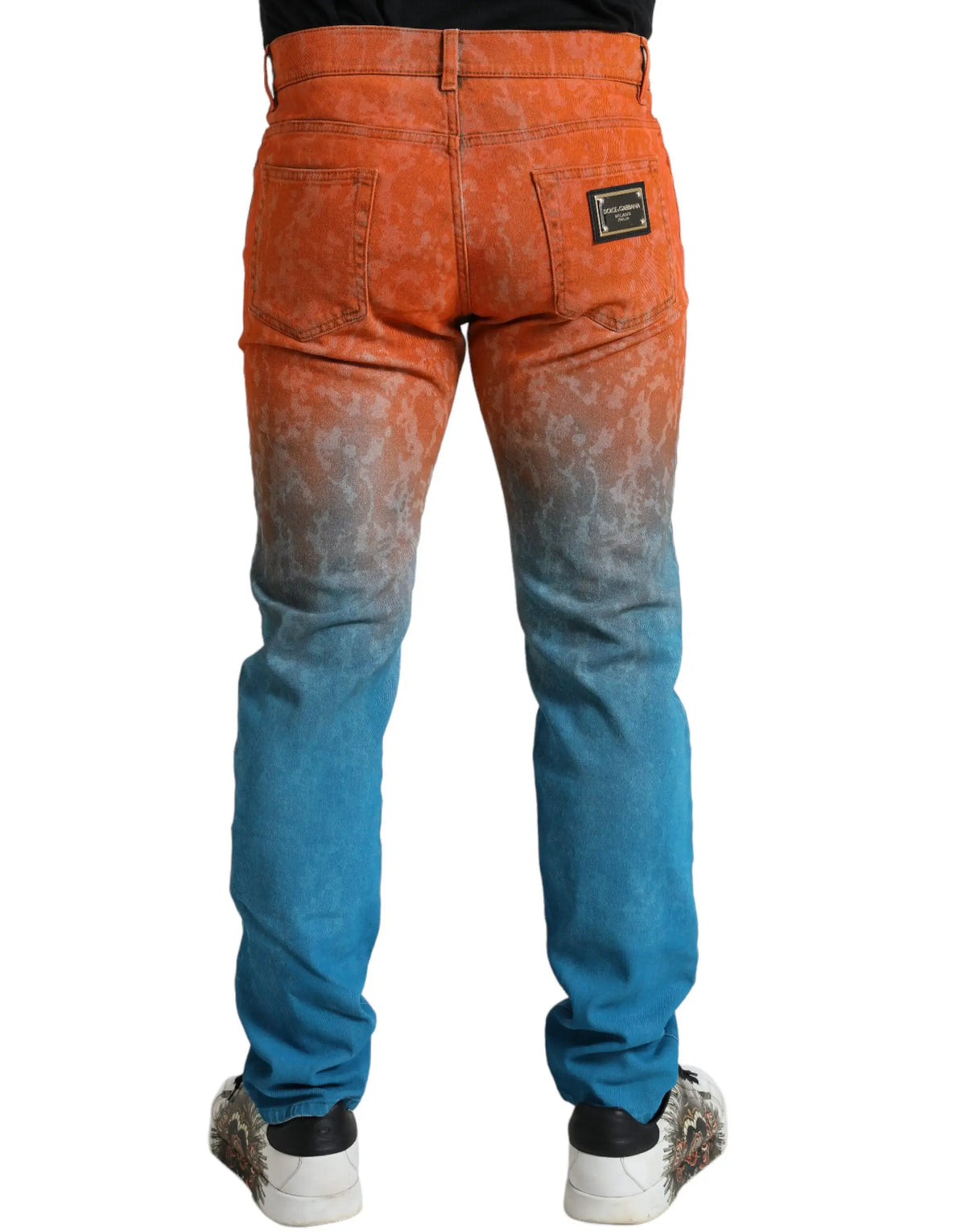 Jean slim en coton dégradé orange et bleu dolce gabbana vue arrière avec patch en cuir noir sur la poche arrière