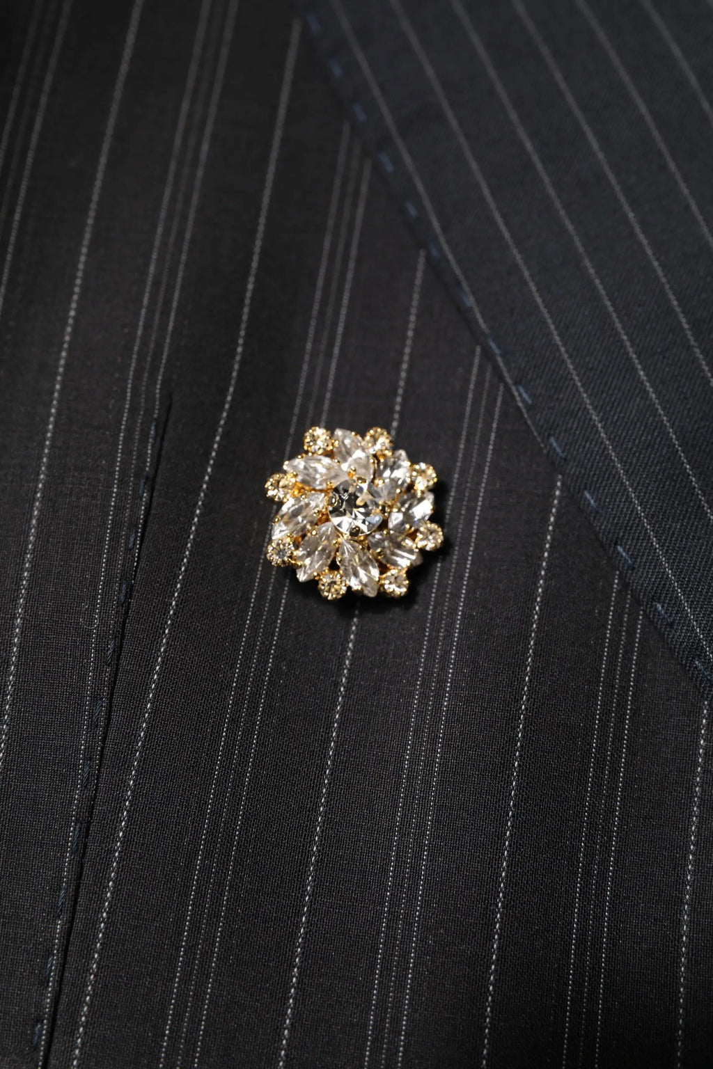 Broche étincelante dorée avec cristaux clairs facettés en motif floral sur veste patchwork multicolore dolce gabbana