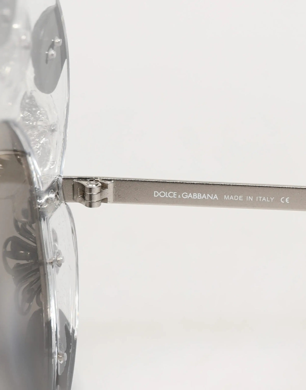 Lunettes de soleil rondes transparentes dolce gabanna dg4292 avec branches métalliques argentées et gravure florale délicate