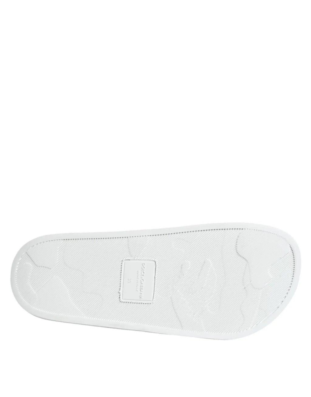 Semelle en caoutchouc blanc avec motif texturé subtil et étiquette dolce gabbana sur sandales en cuir noir et blanc