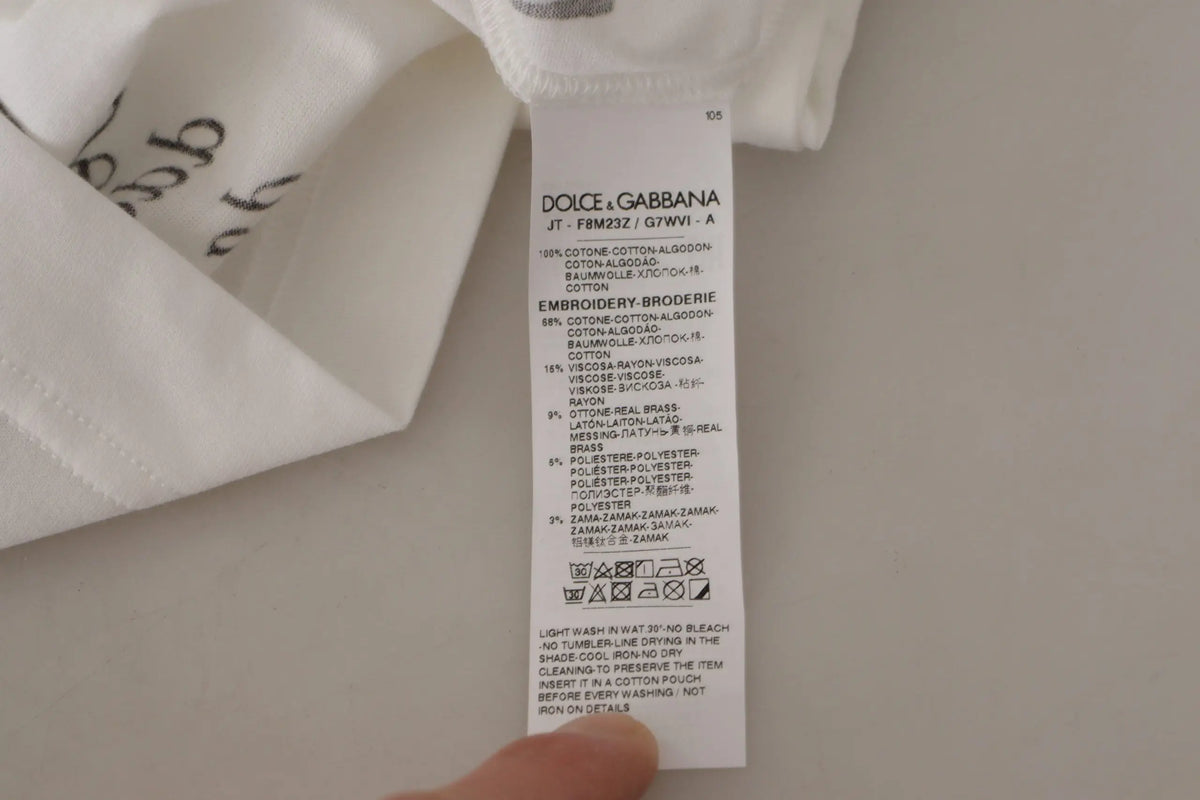 Étiquette blanche dolce & gabbana avec texte noir indiquant la composition et les instructions d entretien pour t shirt coton roses noires