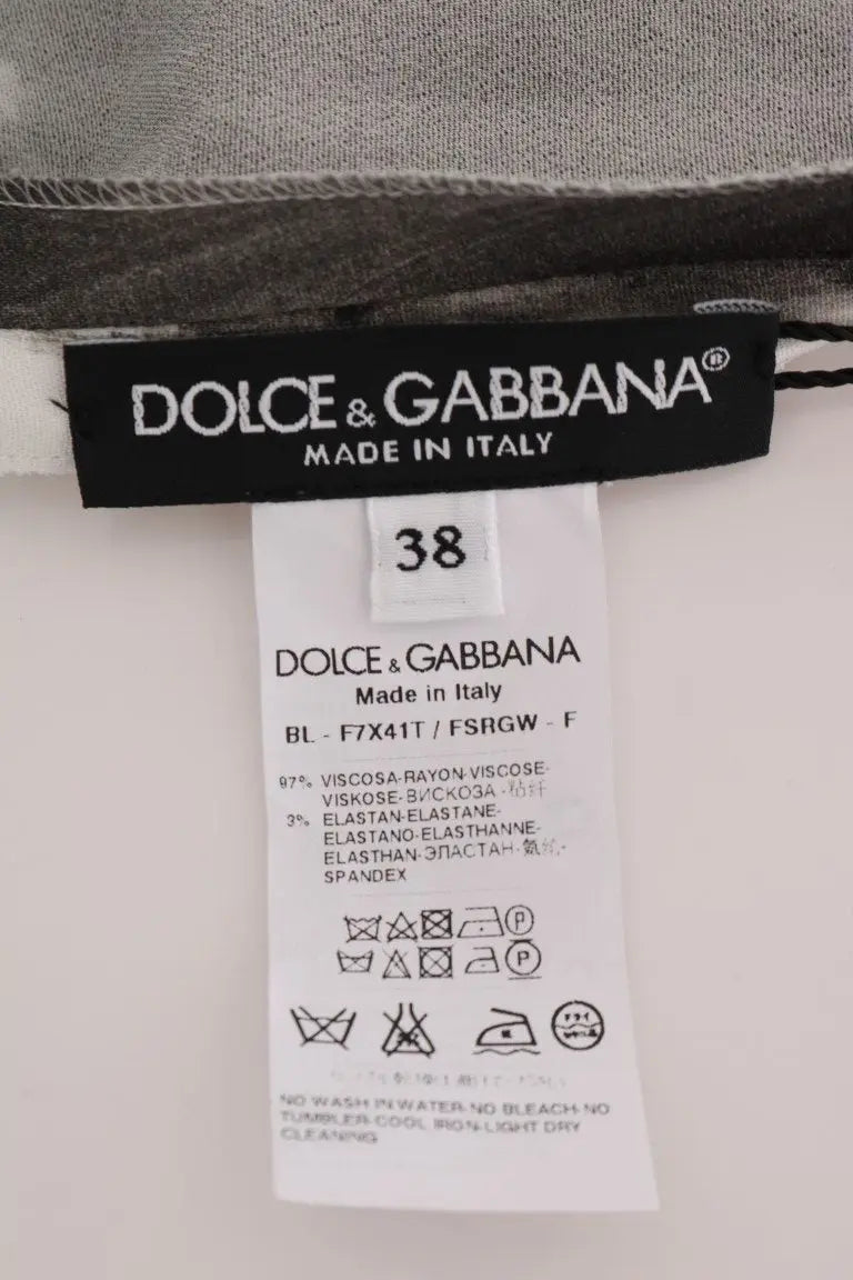 Étiquette noire dolce & gabbana indiquant made in italy et taille 38 sur le dos dun top blouse imprimé rayé blanc et noir