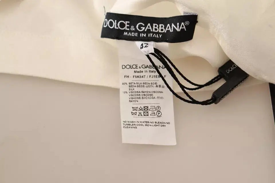 Étiquette du vêtement en soie crème et viscose de dolce & gabbana pour blouse blanche à col ascot et boutons en soie