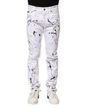 Jeans skinny en denim blanc dolce & gabbana avec un design audacieux de peinture noire éclaboussée