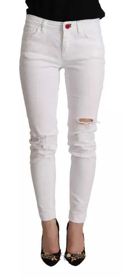 Jeans skinny blanc en denim de coton dolce & gabbana avec bouton rouge et détails en dentelle aux genoux