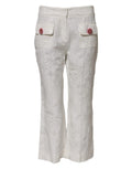 Pantalon blanc en coton dolce & gabbana avec broderie florale et boutons en forme de rose rose sur les poches avant