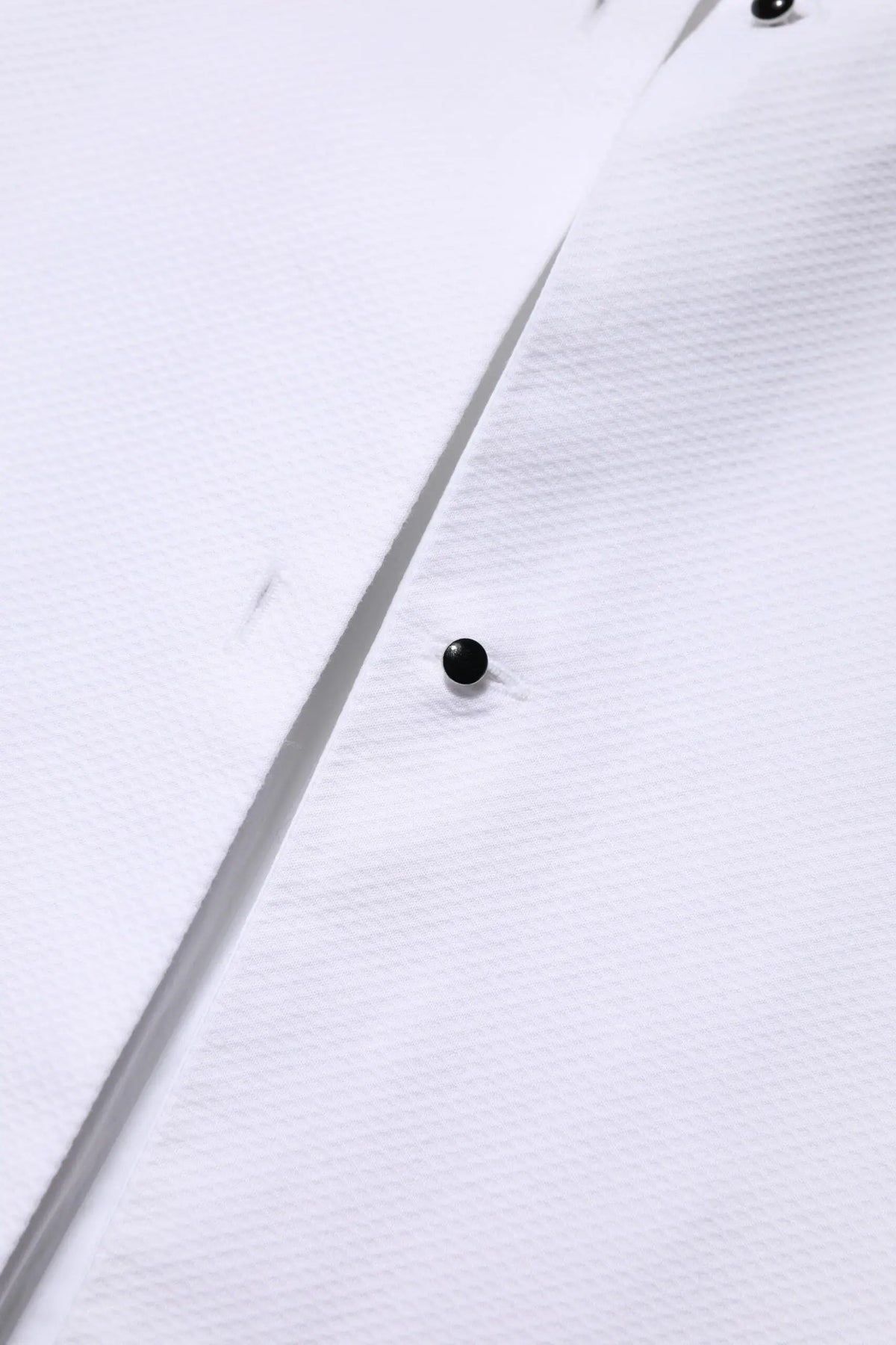 Bouton noir sur tissu blanc du top chemise col long en coton blanc dolce & gabbana
